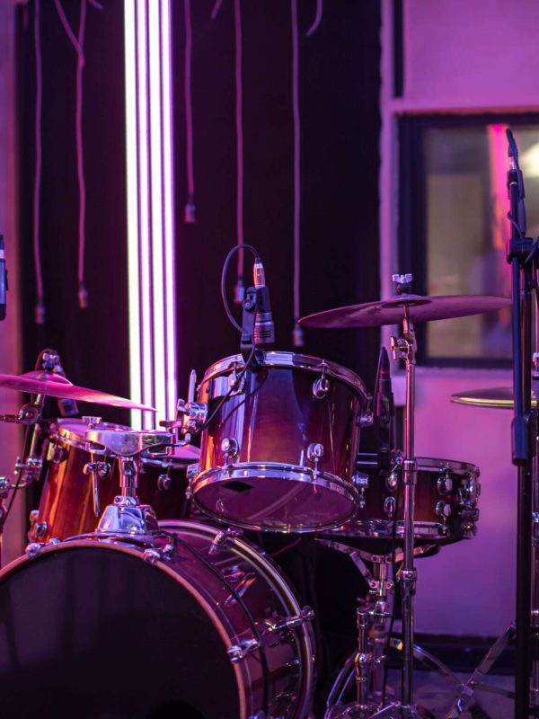 Bright recording Studio. A room for musicians ' rehearsals, with a drum kit in the background. The concept of musical creativity and show business.